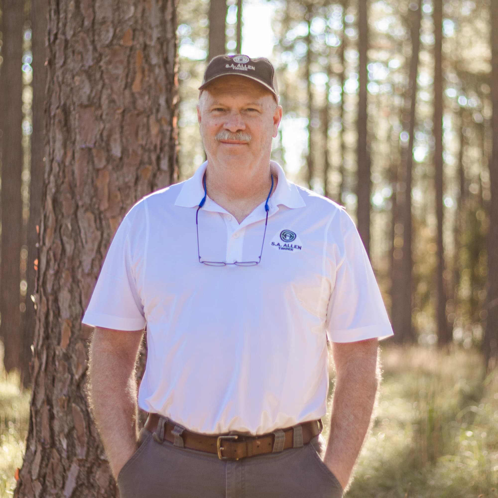 man infront of wood