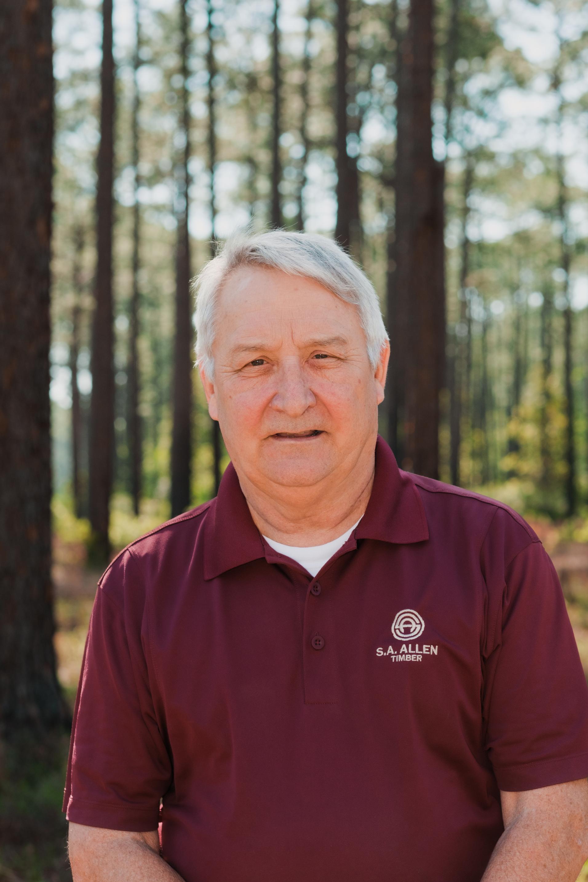 man in front of wood