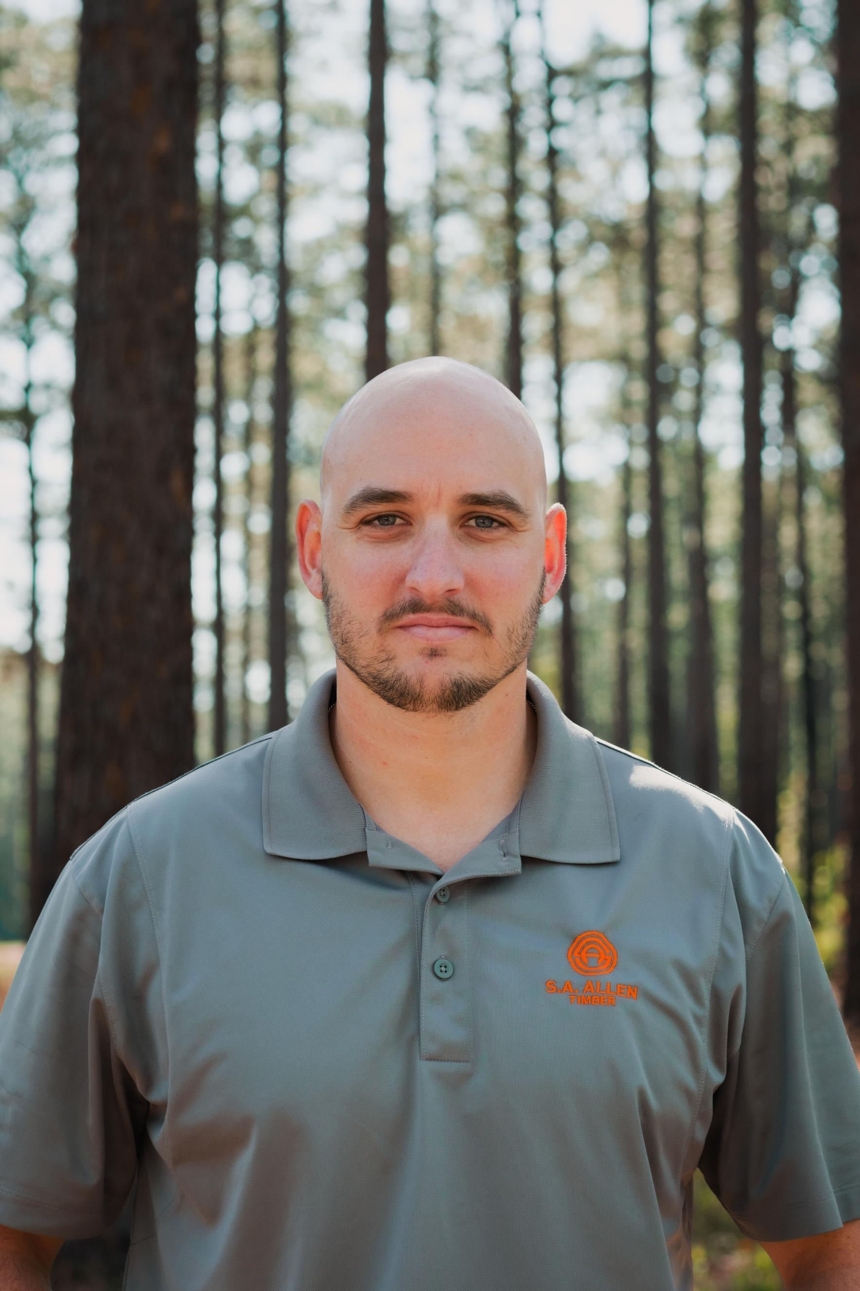 man in front of wood