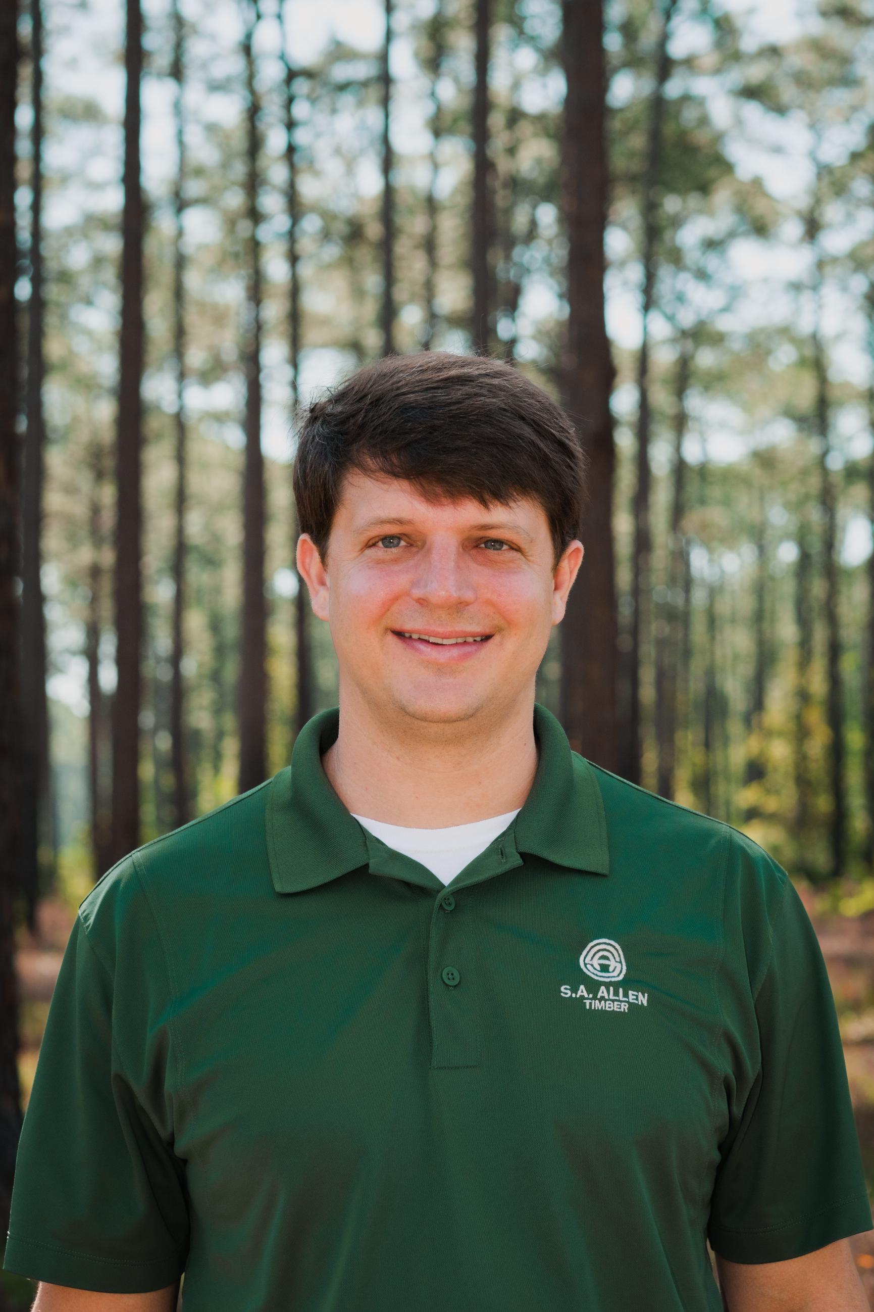 man in front of wood